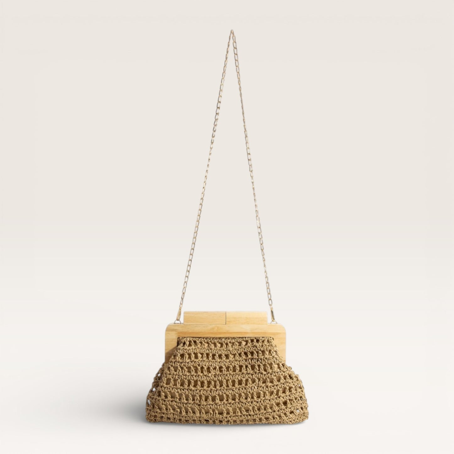 Woven handbag with wooden top and chain strap on a light gray background