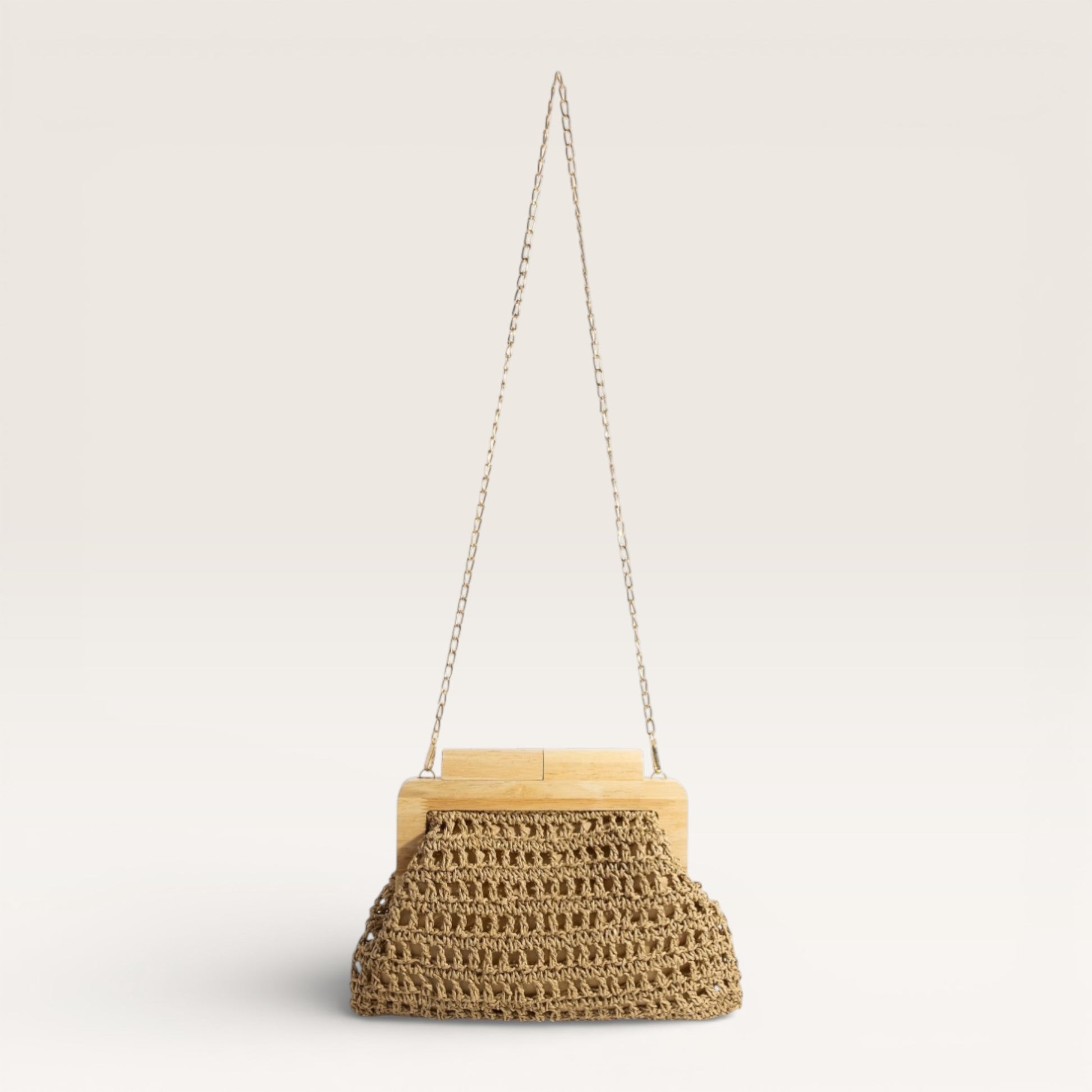 Woven handbag with wooden top and chain strap on a light gray background