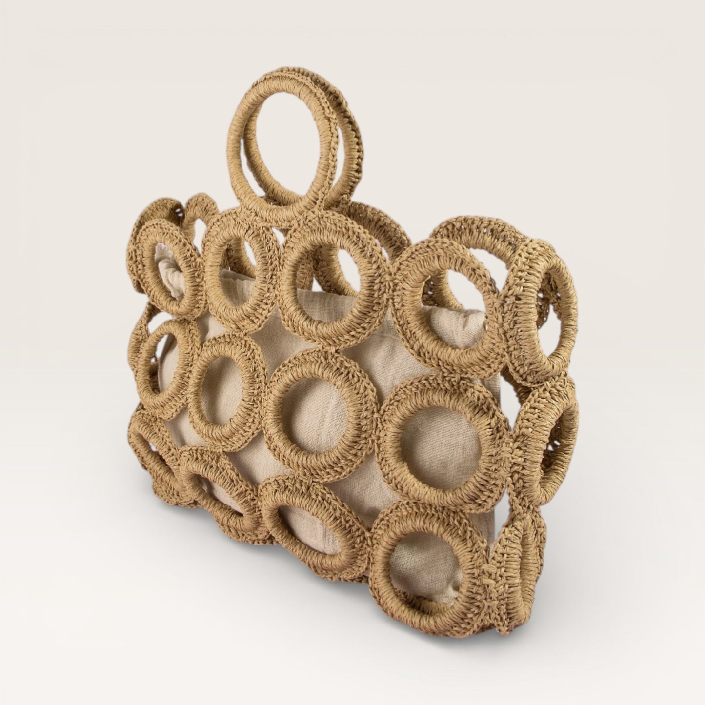 Brown woven basket with circular patterns on a light beige background