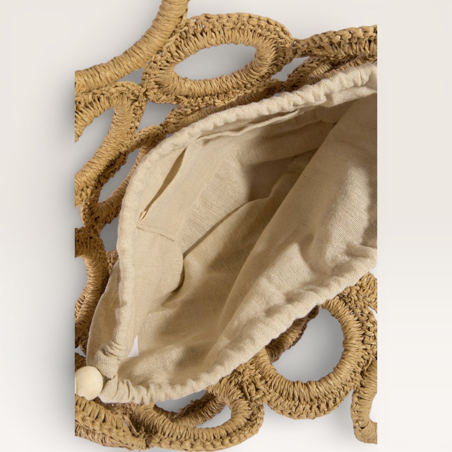 Decorative wall piece with beige fabric and woven brown frame on a white background