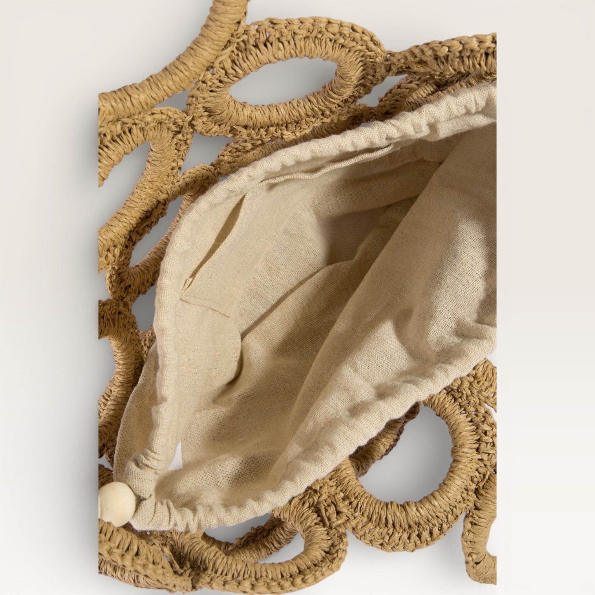 Decorative wall piece with beige fabric and woven brown frame on a white background