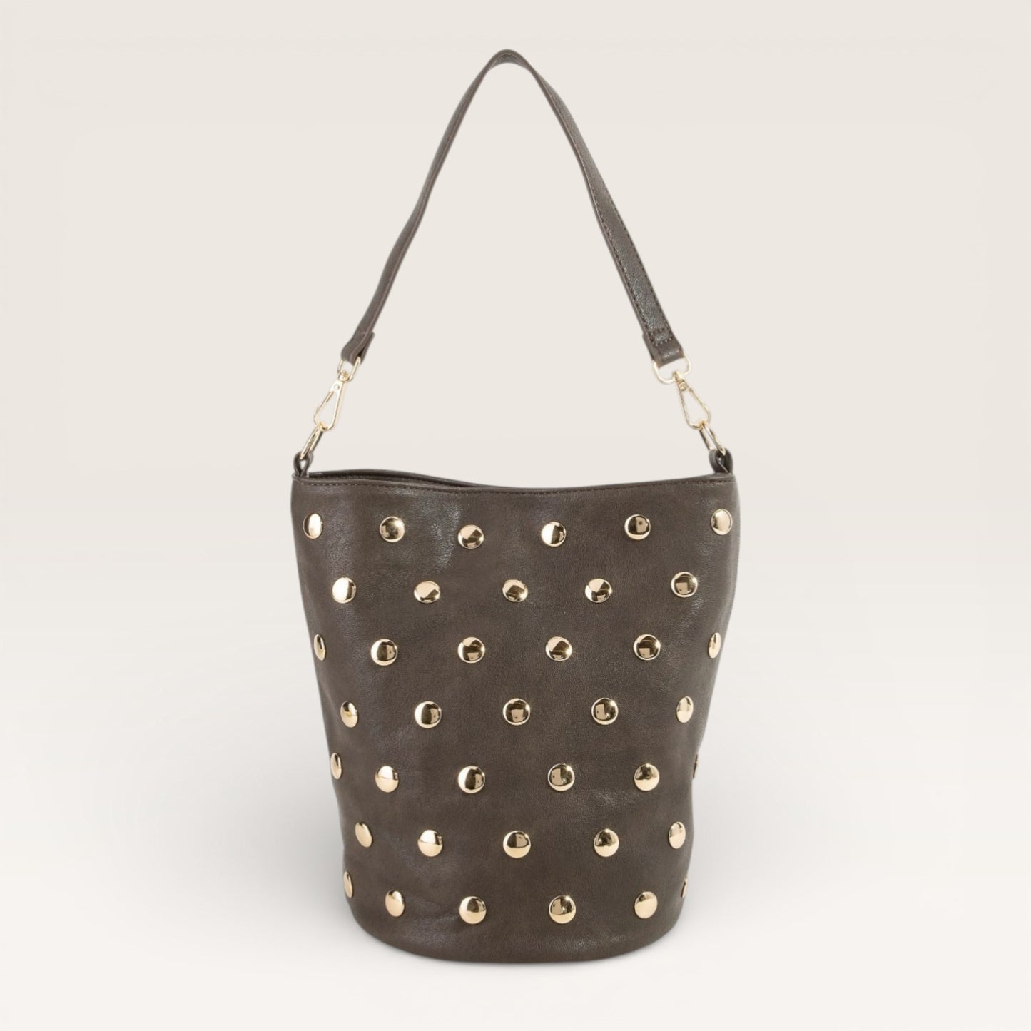 Gray handbag with gold studs on a light gray background