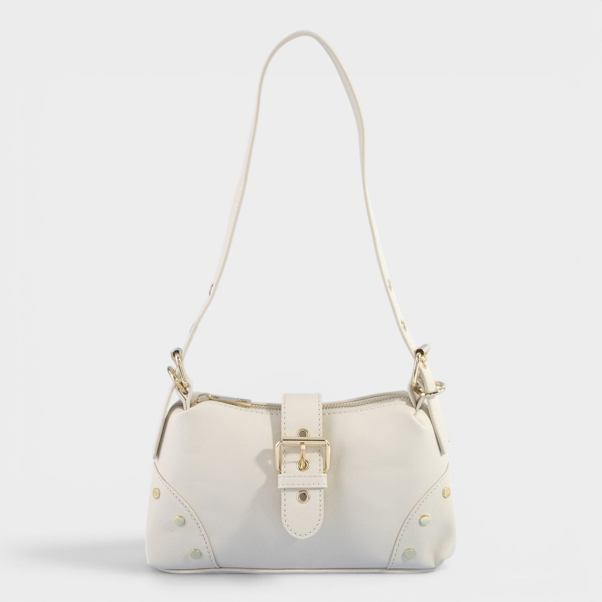 White handbag with gold accents on a light gray background