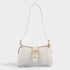 White handbag with gold accents on a light gray background