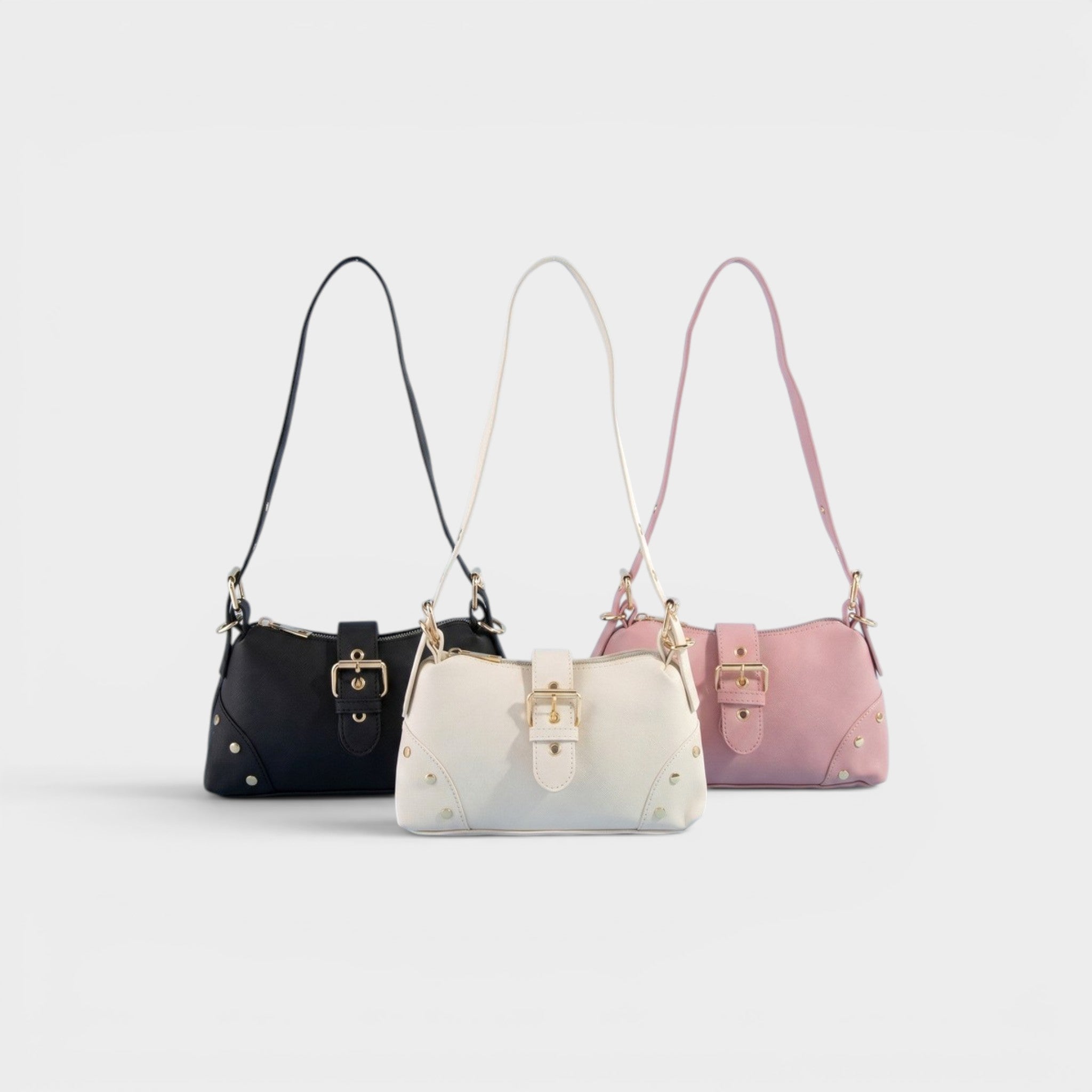 Three handbags in black, white, and pink on a light gray background