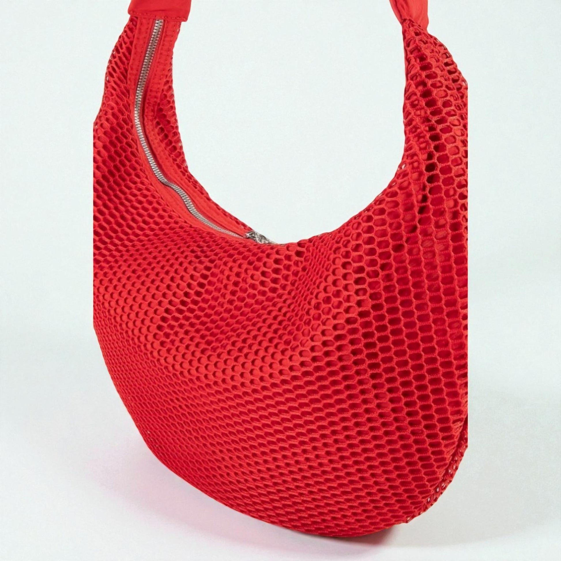 Red mesh handbag on a white background