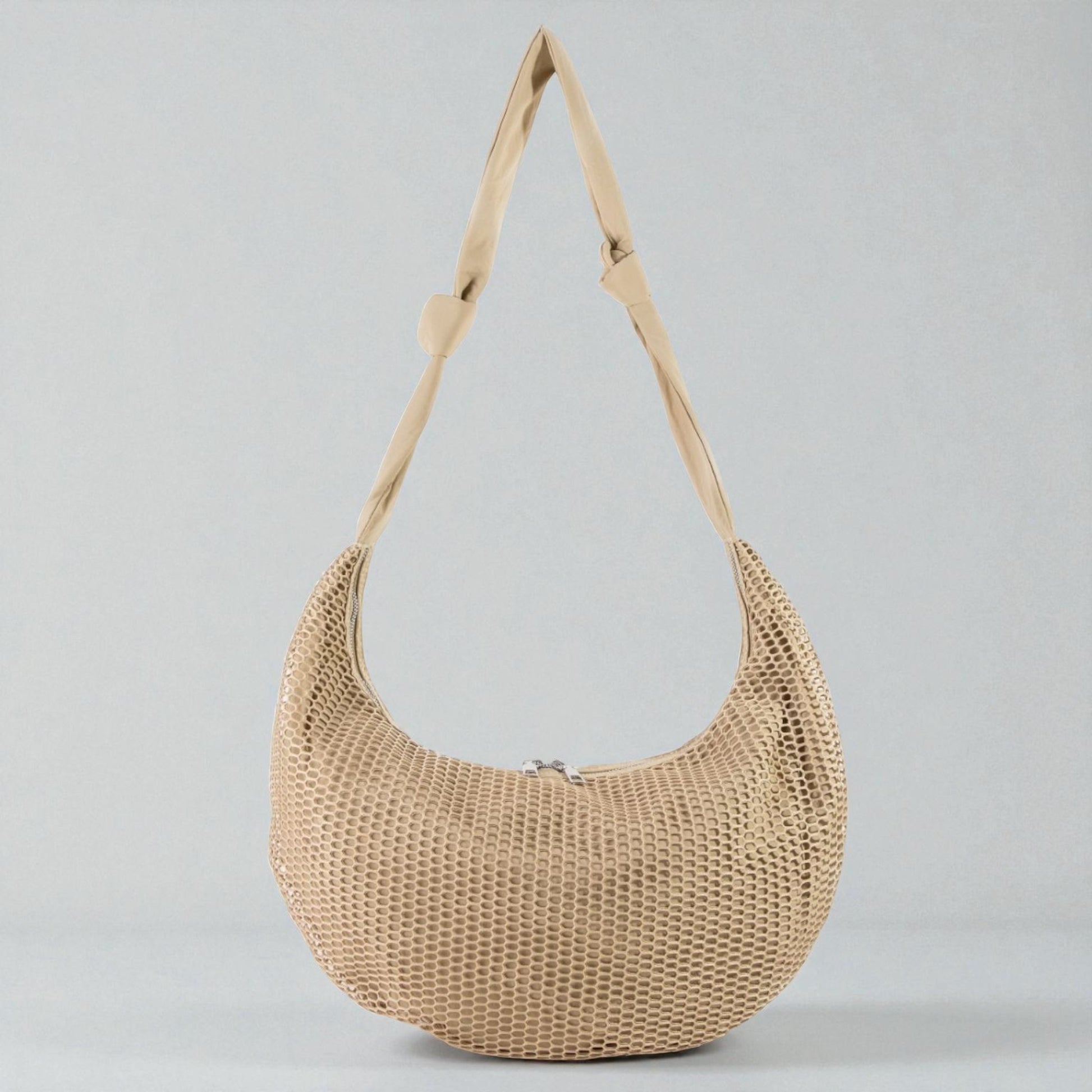 Beige woven handbag with a strap on a light gray background