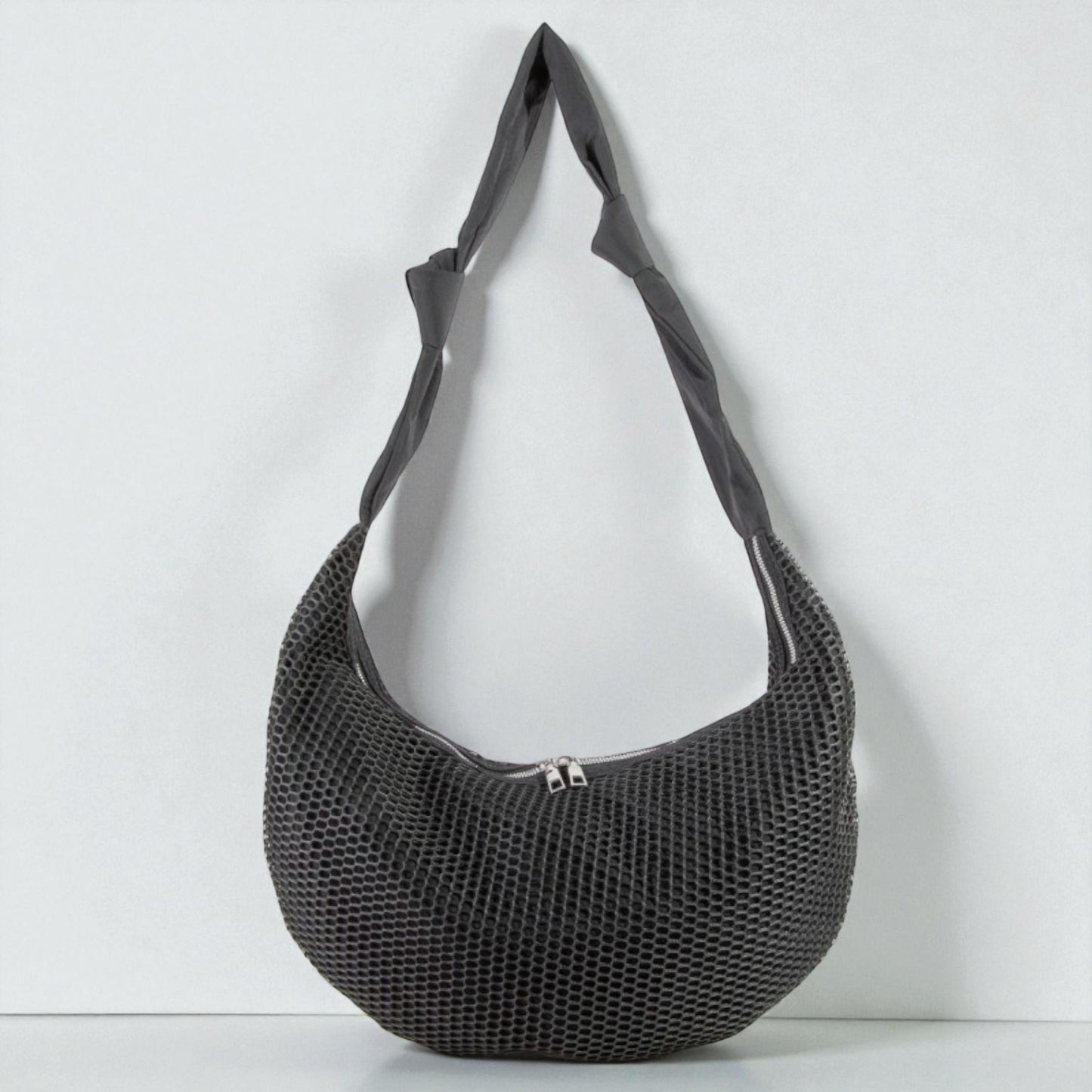 Black mesh handbag on a white background