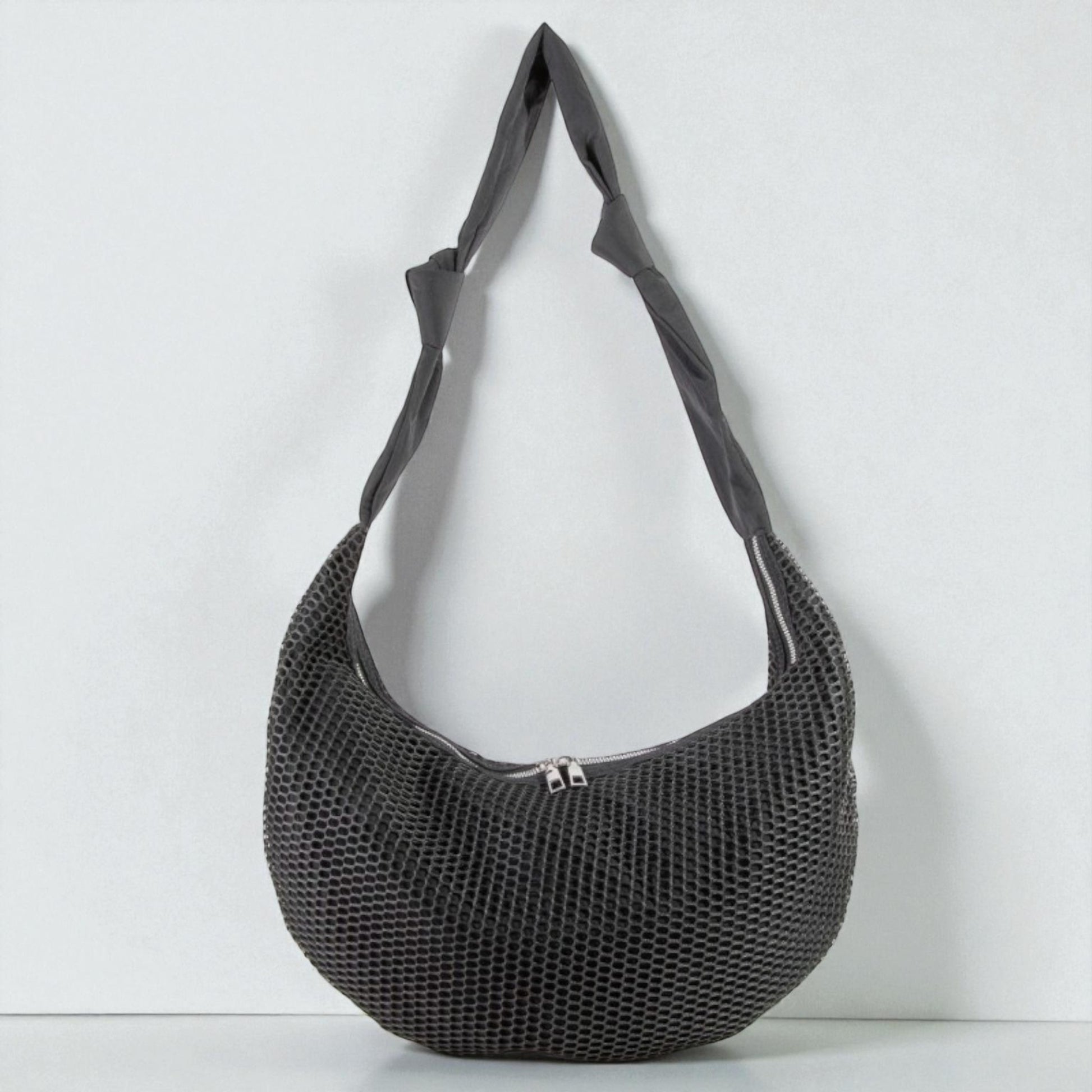 Black mesh handbag on a white background