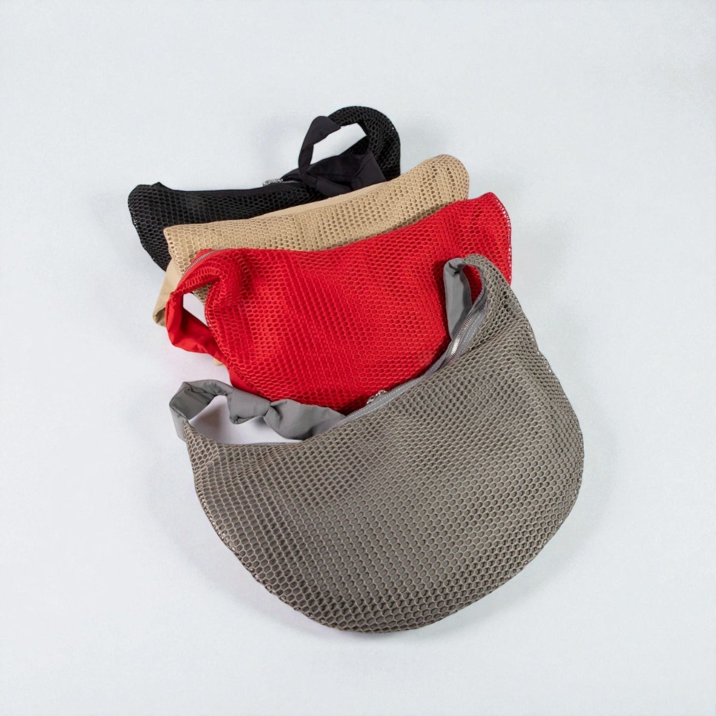 Set of four mesh bags in black, beige, red, and gray on a white background
