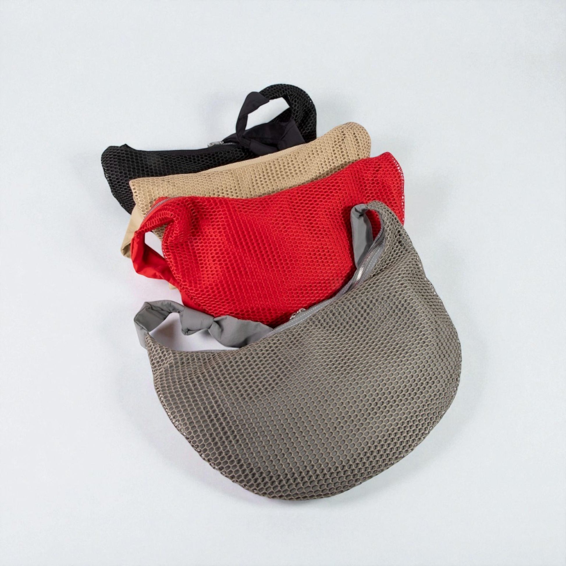 Set of four mesh bags in black, beige, red, and gray on a white background