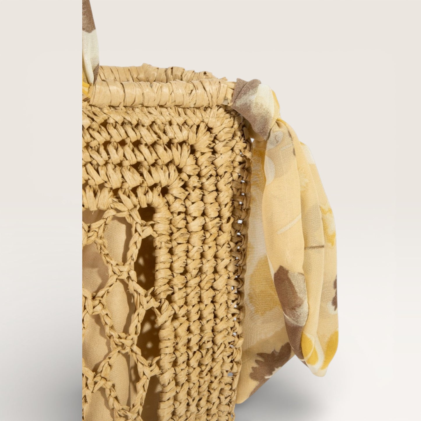 Woven basket with a floral ribbon on a light gray background