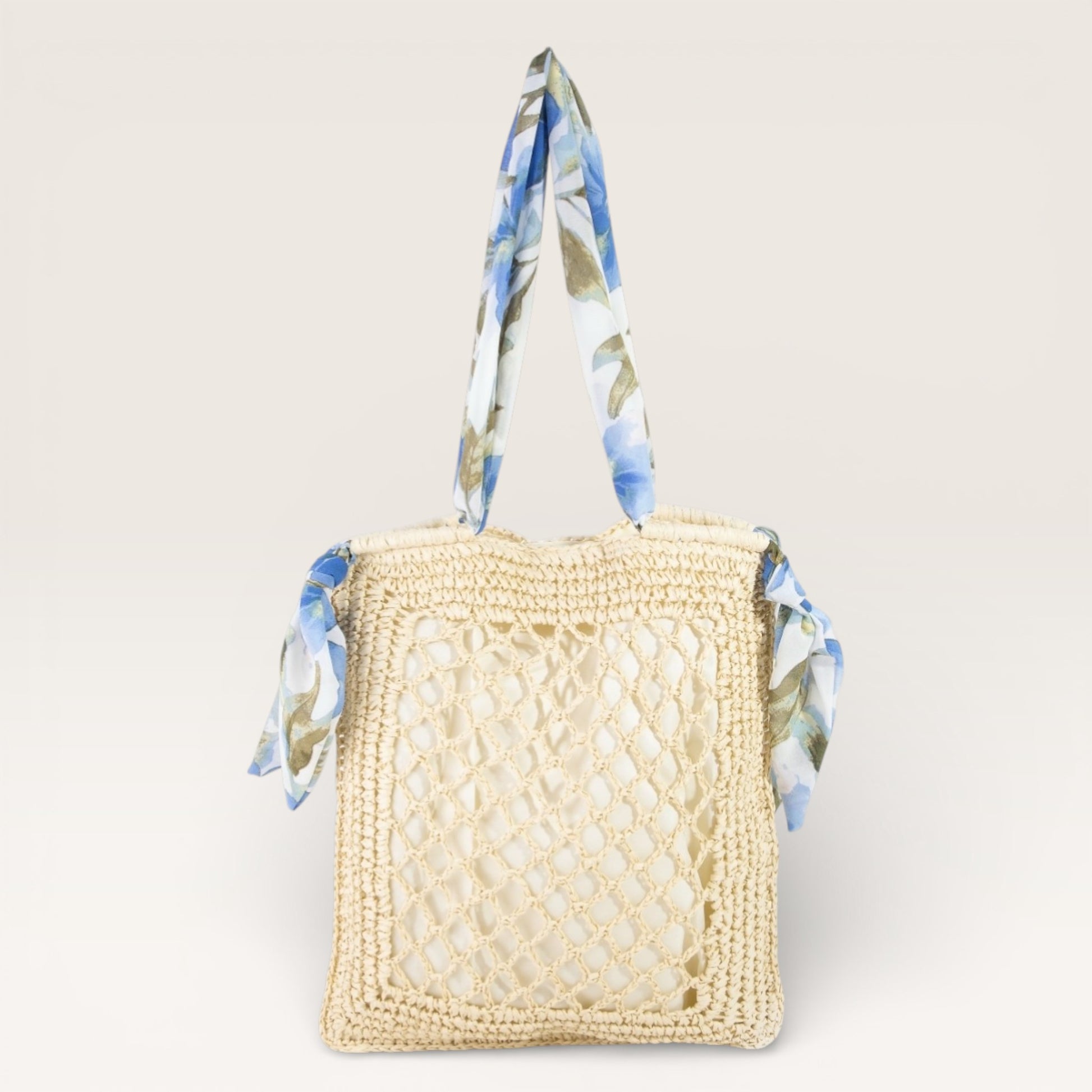 Woven handbag with floral handle on a light beige background