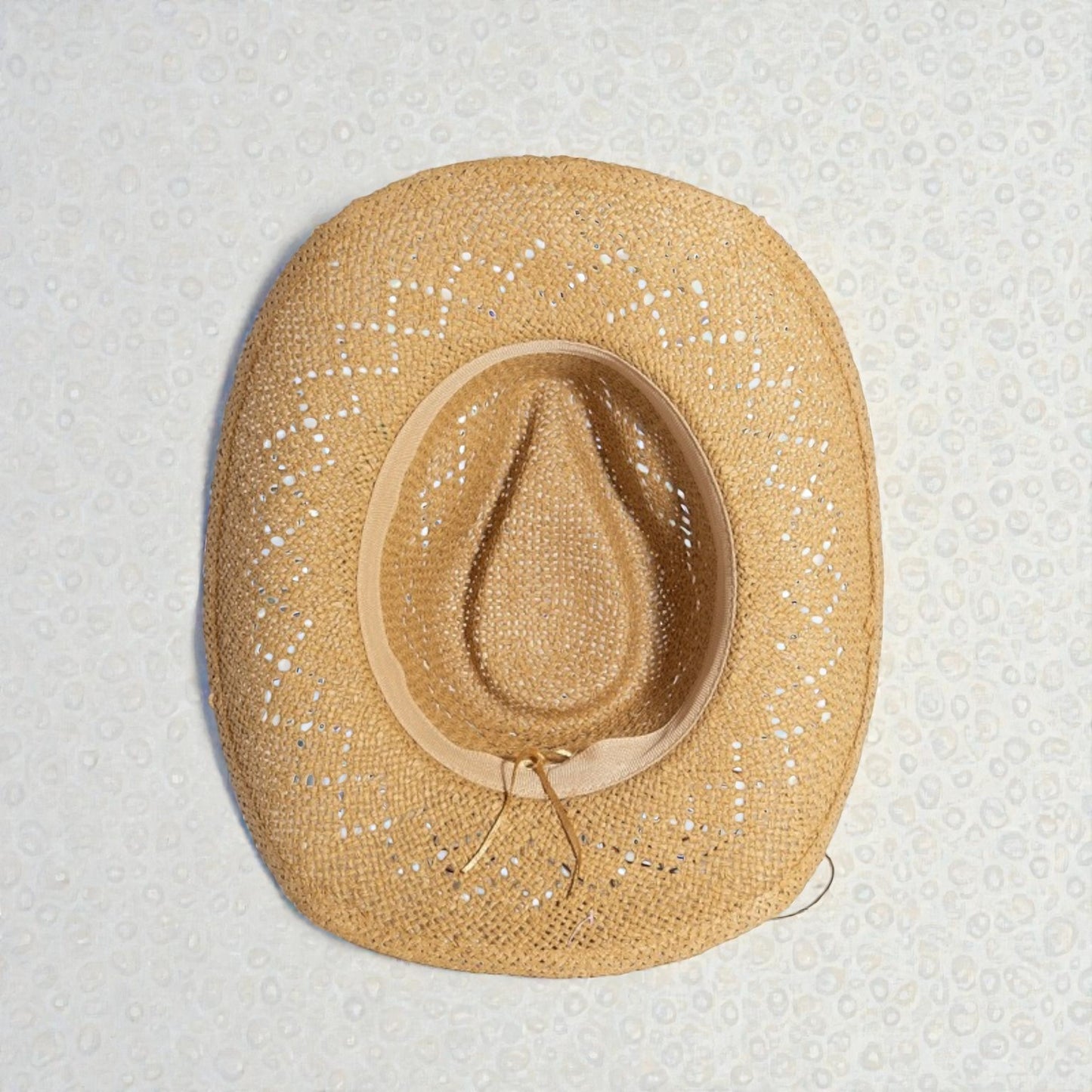 Straw hat with a textured surface on a light gray background