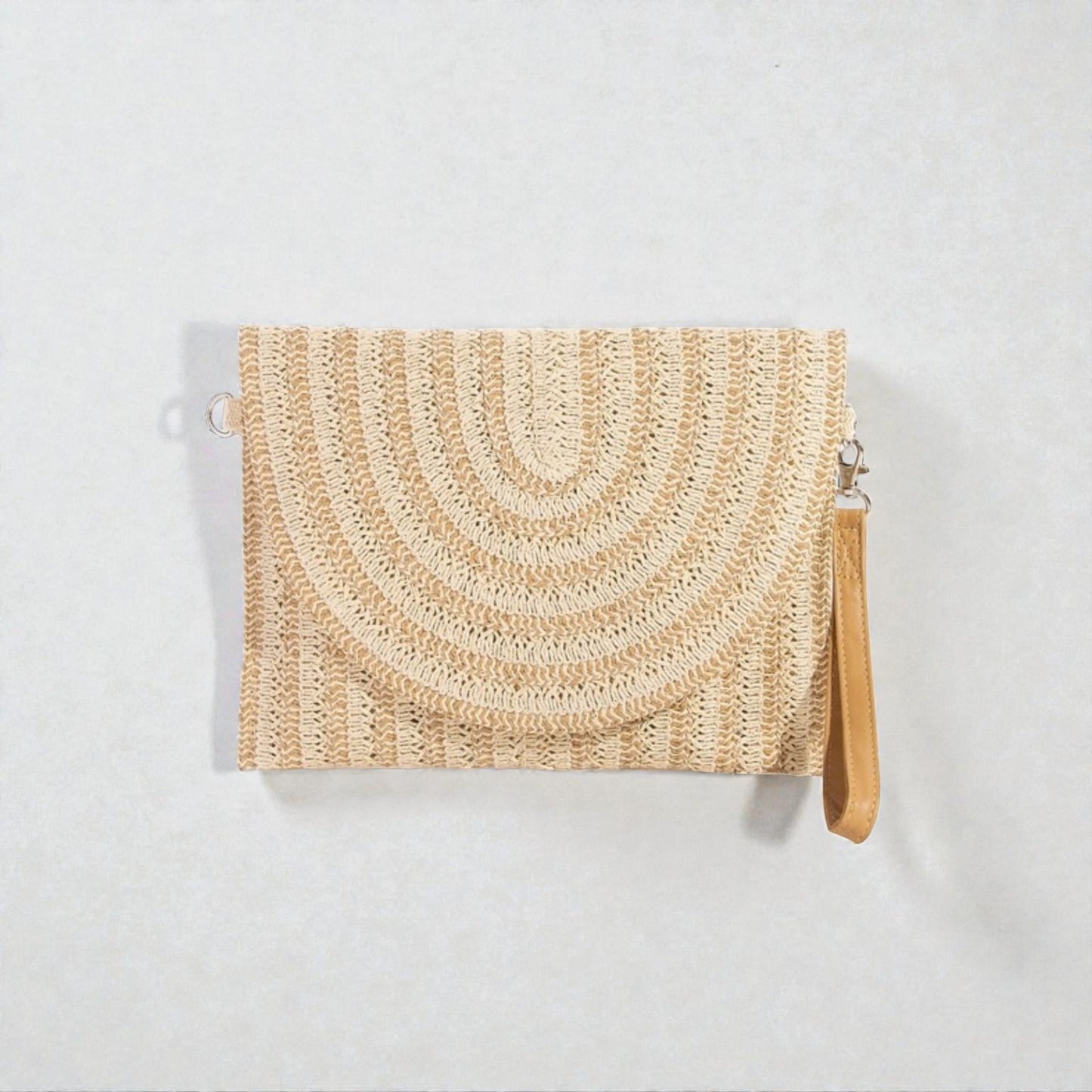 Woven clutch bag with a strap on a light gray background