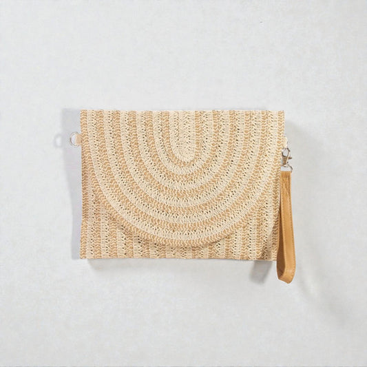 Woven clutch bag with a strap on a light gray background