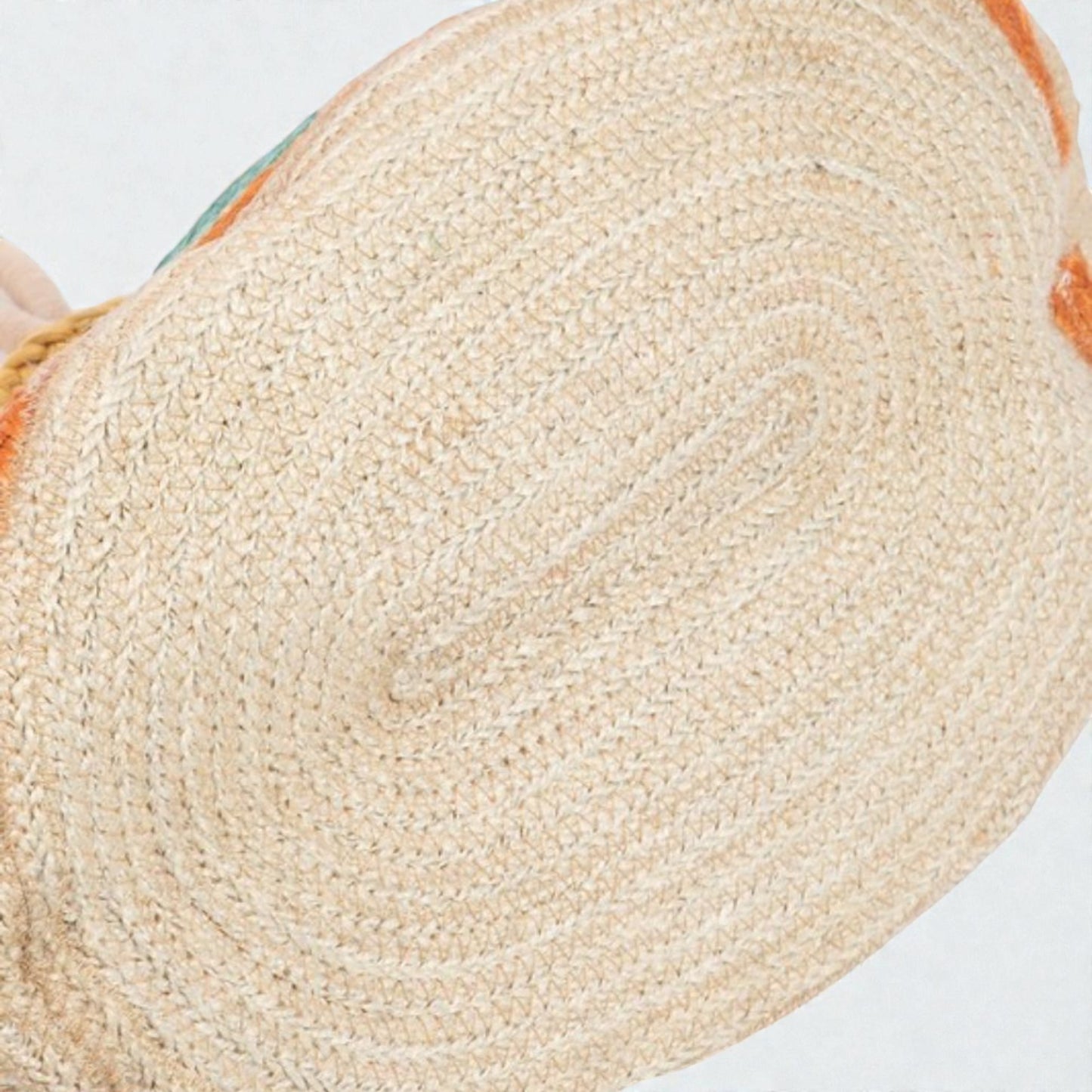 Close-up of a woven mat with a textured surface on a light background