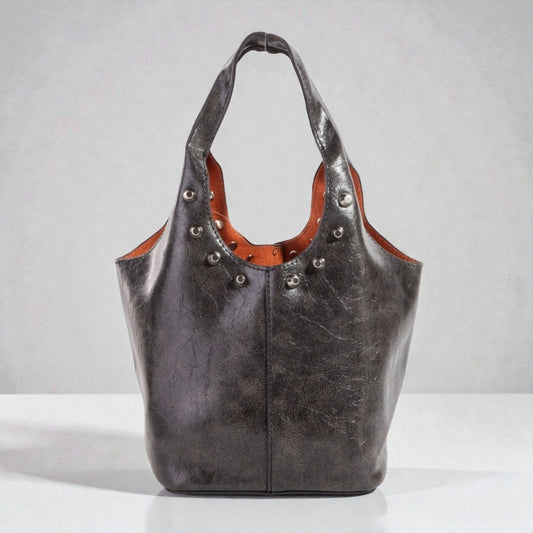 Black leather handbag with brown interior on a white background