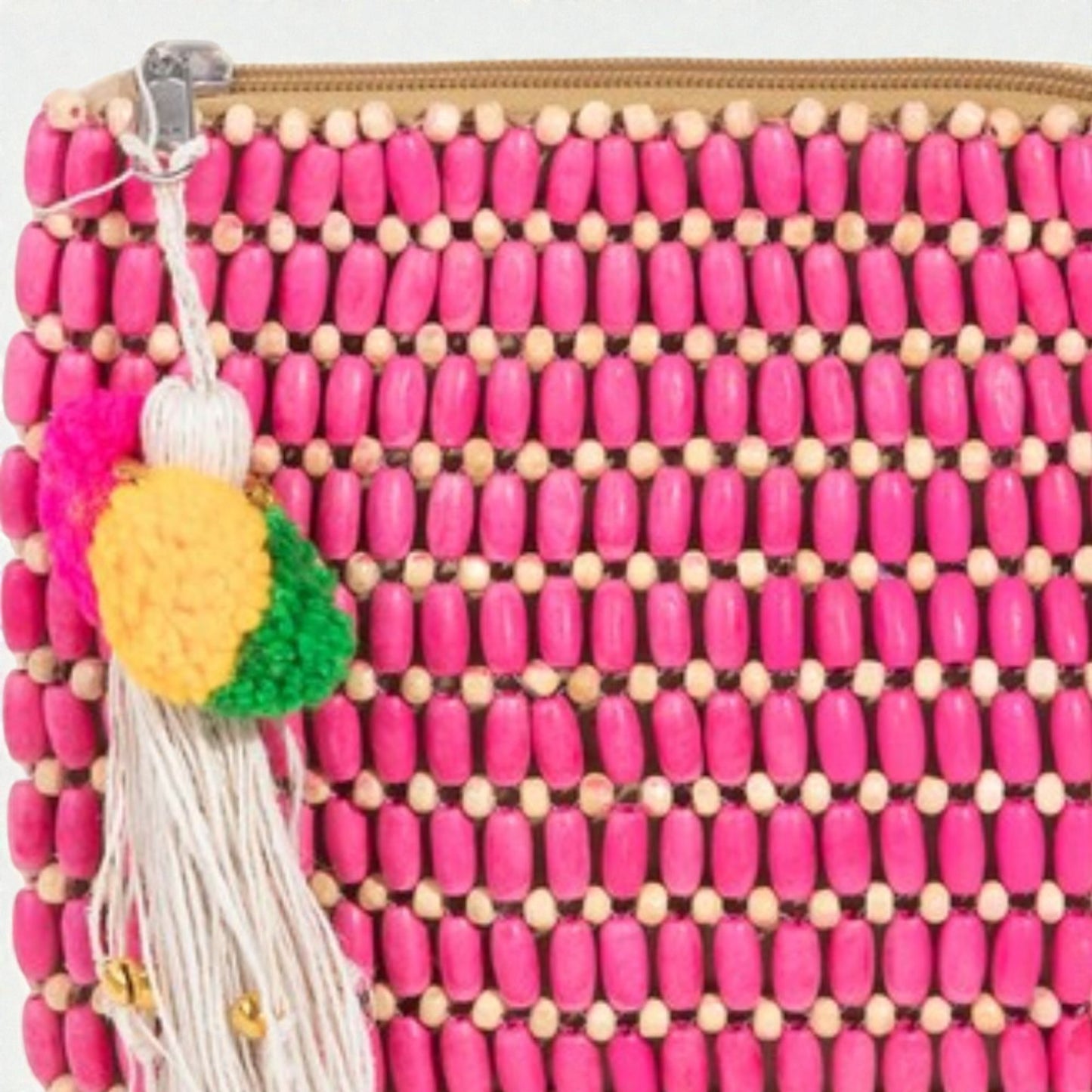 Pink beaded pouch with a yellow pineapple charm and tassel