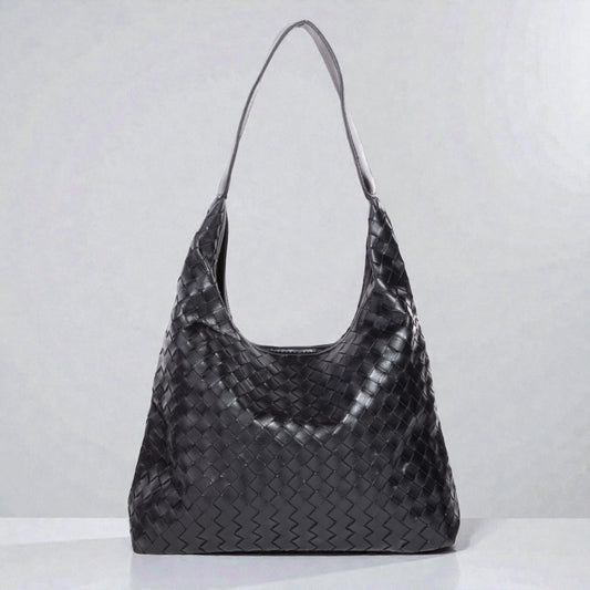 Black woven handbag on a white background