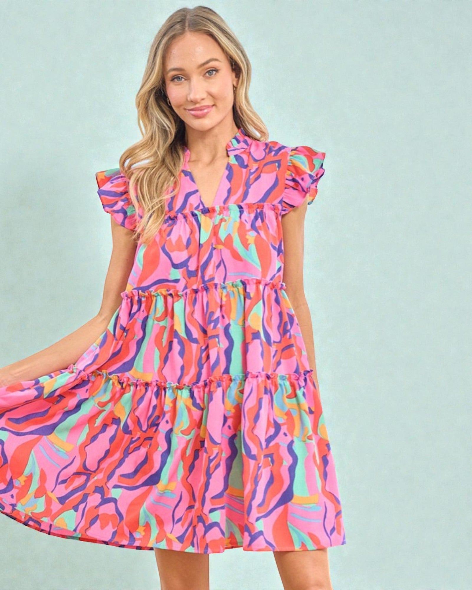 Woman wearing a colorful dress with a light blue background