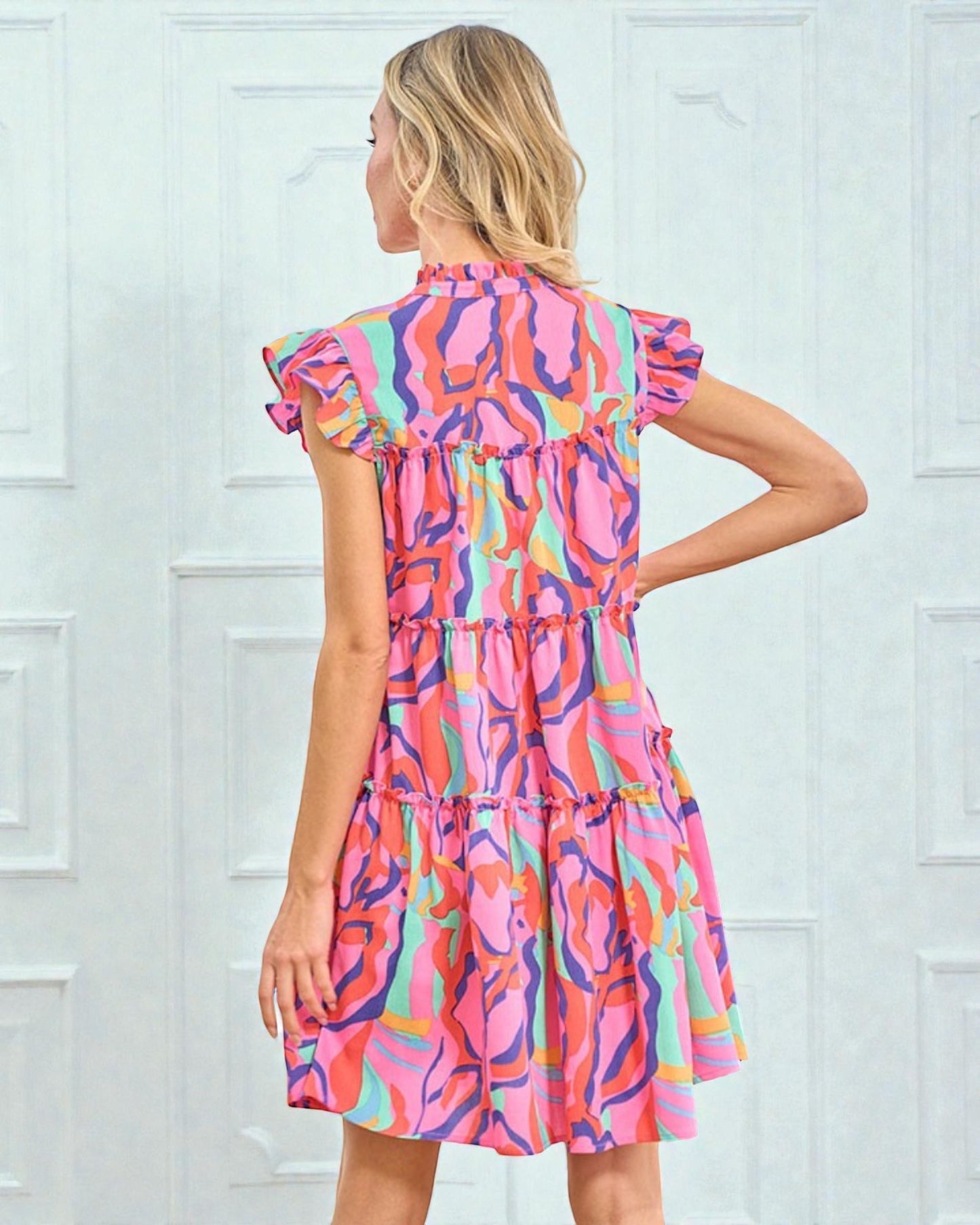 Woman wearing a colorful dress with a white background