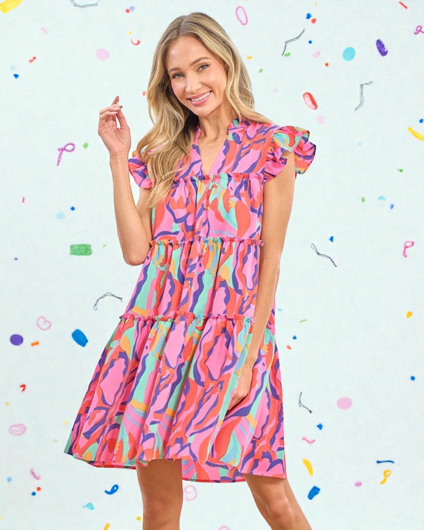 Woman wearing a colorful dress against a light blue background with confetti-like shapes.