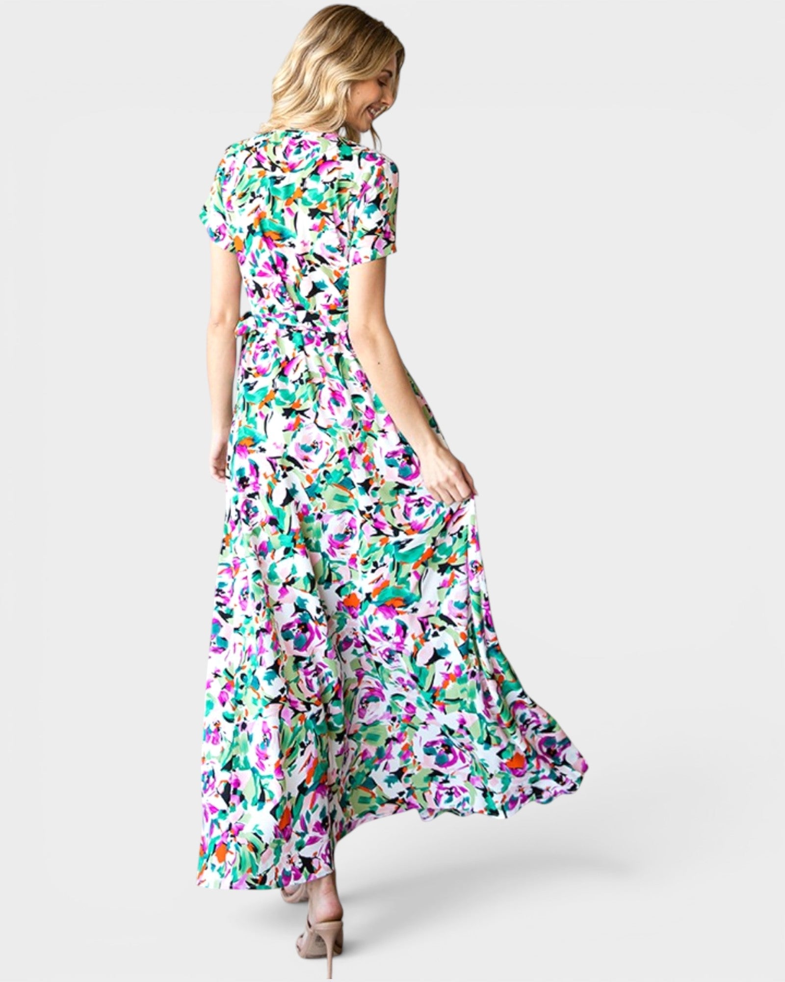 Woman wearing a colorful floral dress on a white background