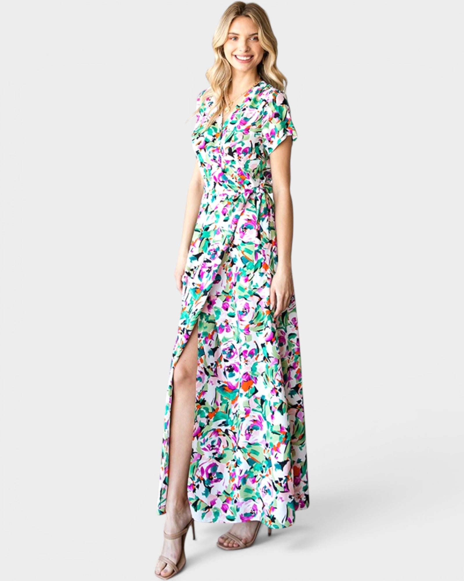 Woman wearing a colorful floral dress on a white background