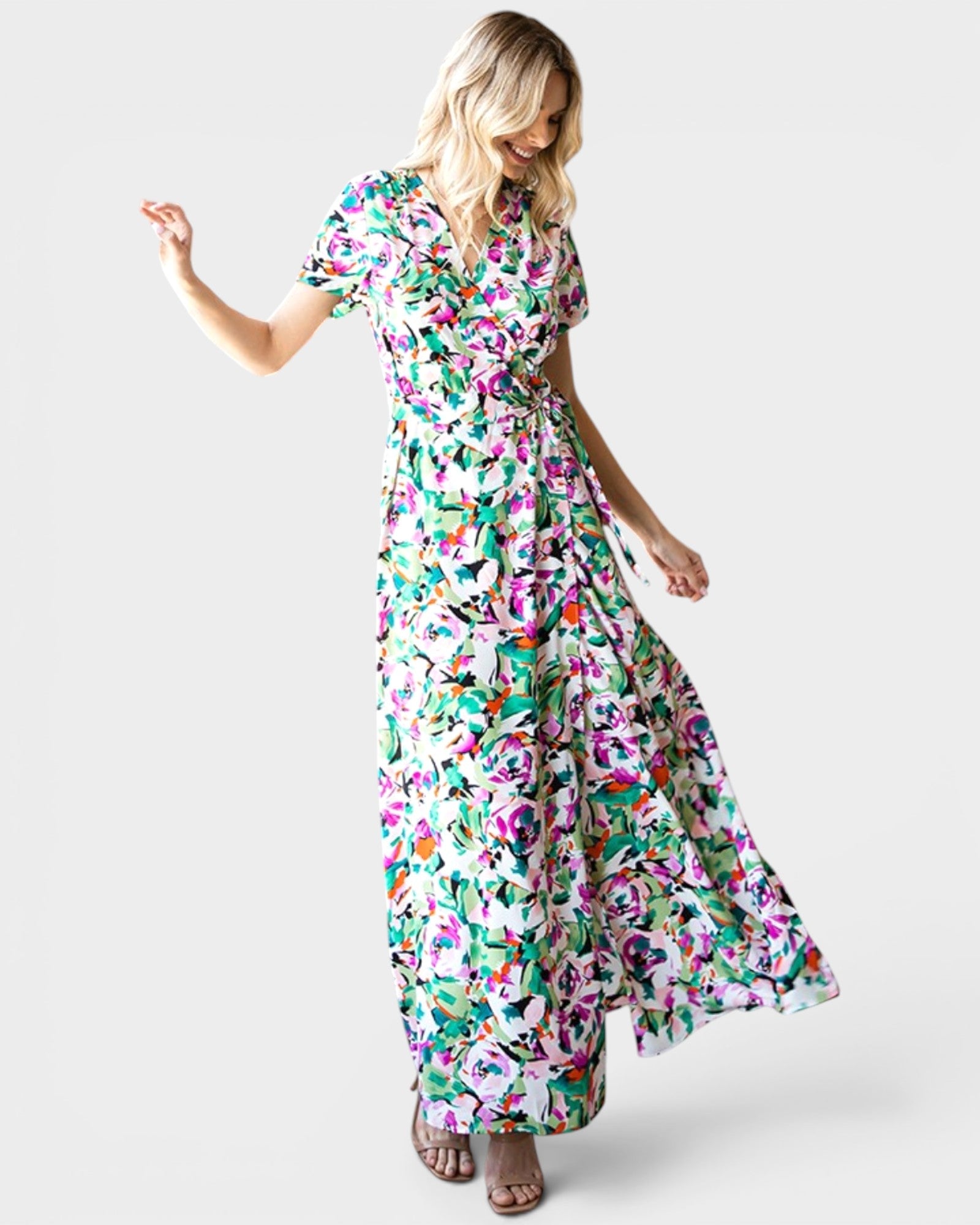 Woman wearing a colorful floral dress on a white background