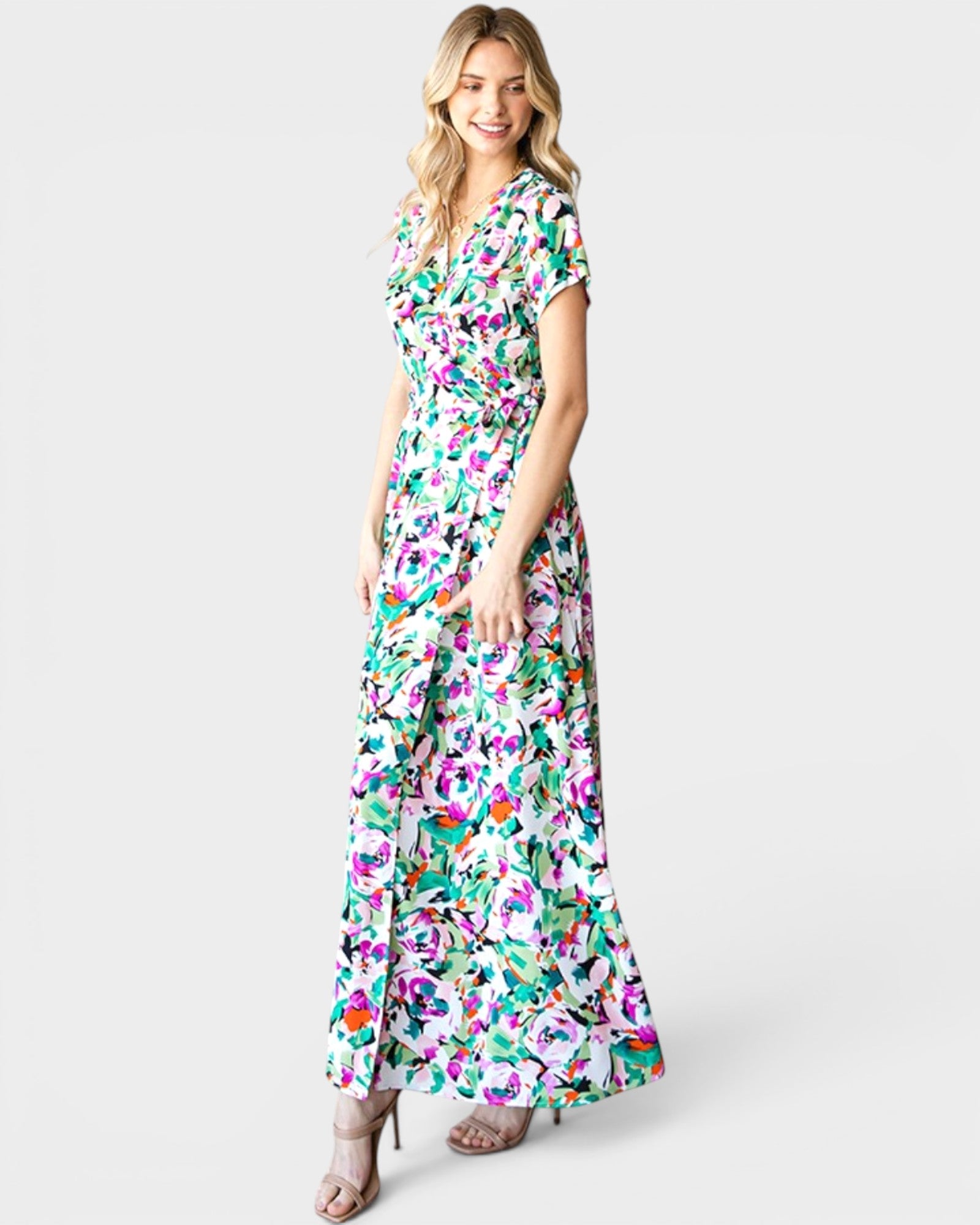 Woman wearing a colorful floral dress on a white background