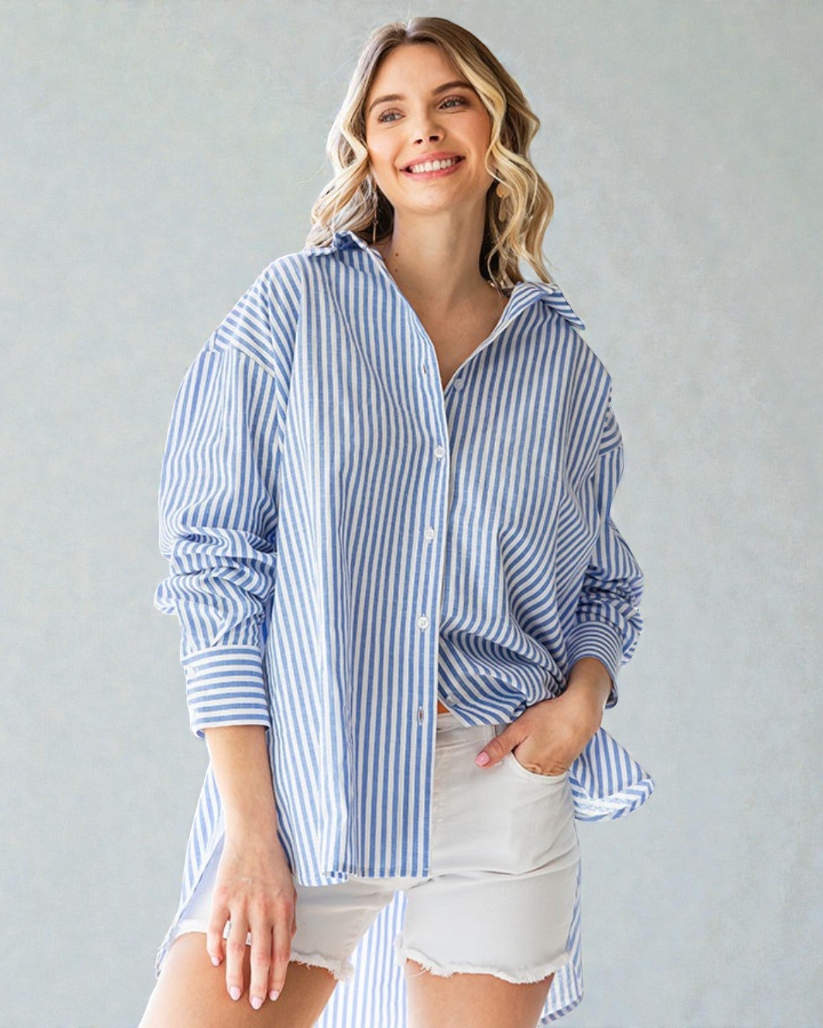 Woman wearing a blue and white striped shirt with a plain background