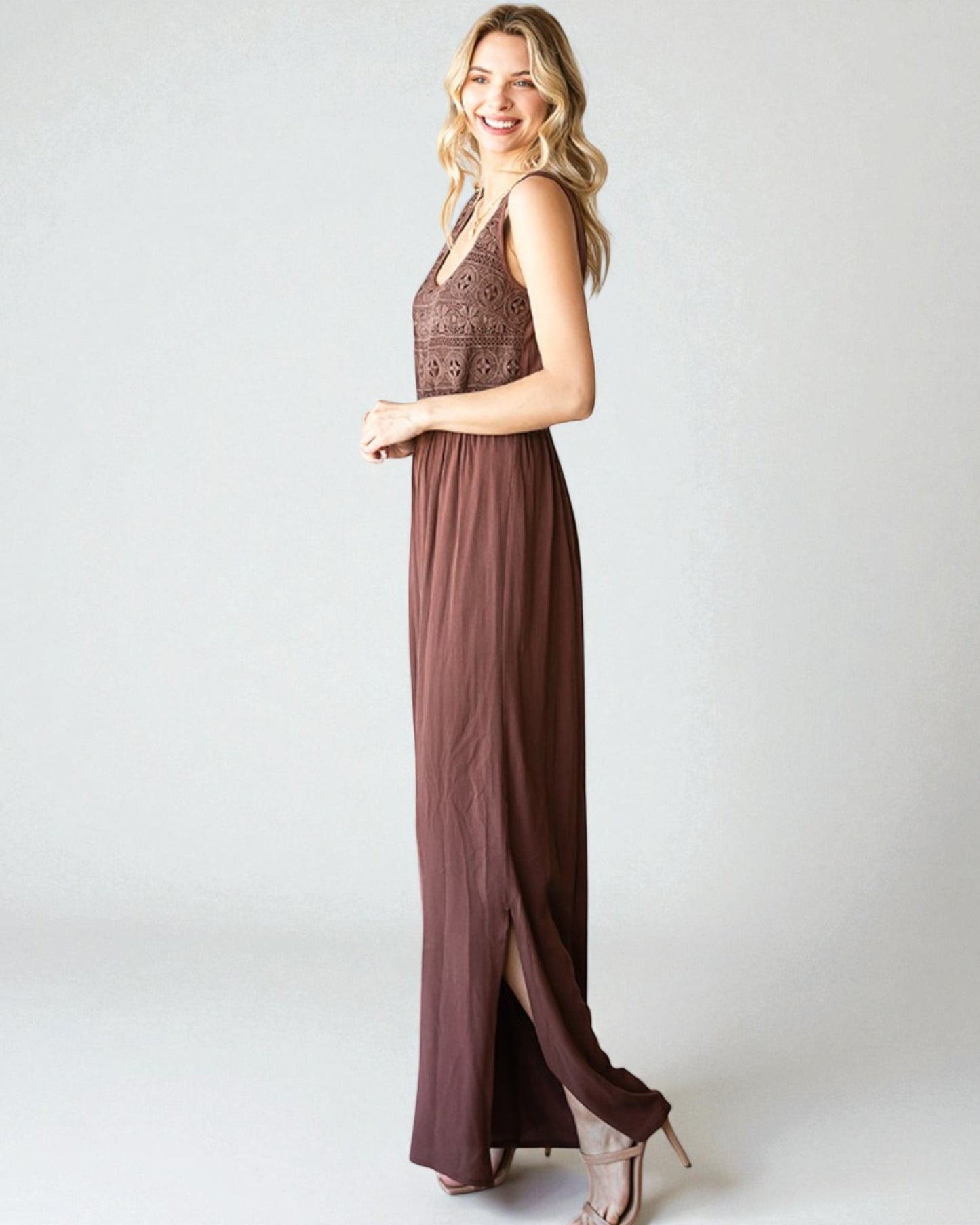 Woman wearing a brown dress with a white background