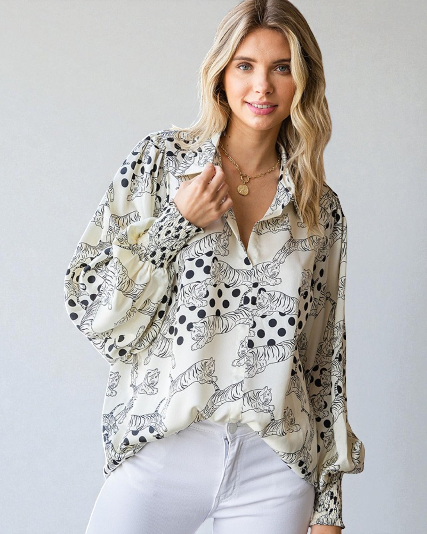 Woman wearing a patterned blouse with a plain background