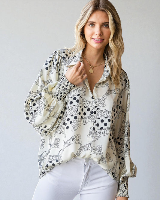 Woman wearing a patterned blouse with a plain background