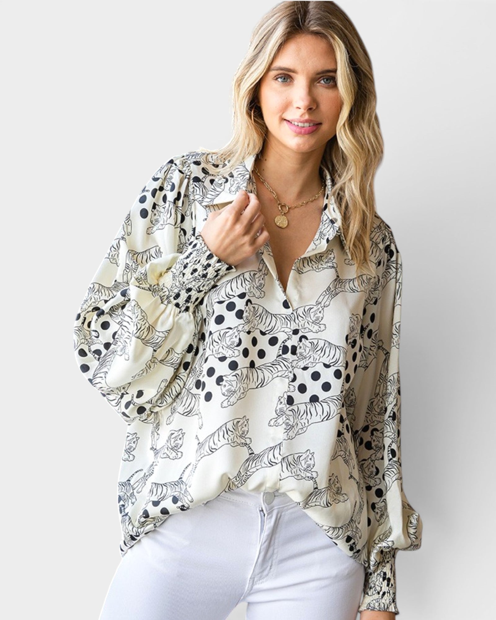 Woman wearing a patterned blouse with a plain background