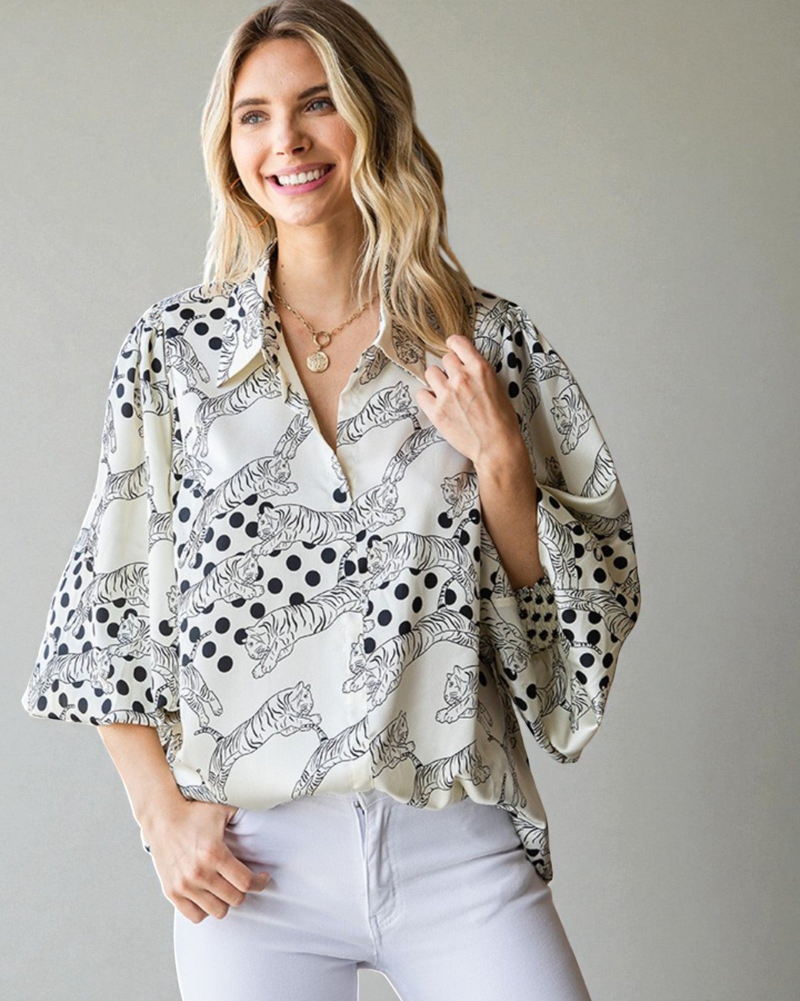 Woman wearing a patterned blouse with a plain background