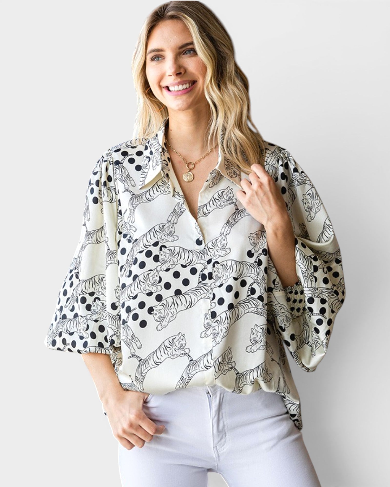 Woman wearing a patterned blouse with a plain background