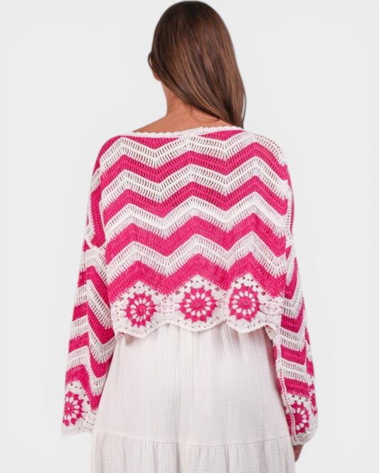 Woman wearing a pink and white patterned shawl on a plain background