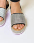 Silver embellished sandals on a light background