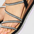 Black strappy sandal with rhinestone details on a white background