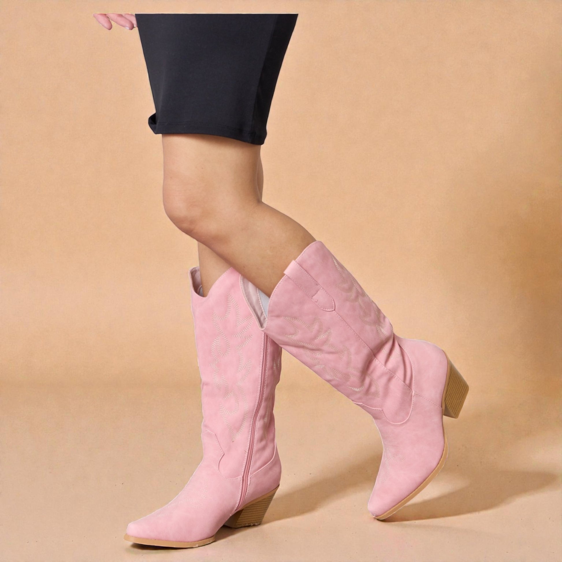 Pink knee-high boots worn with a beige background