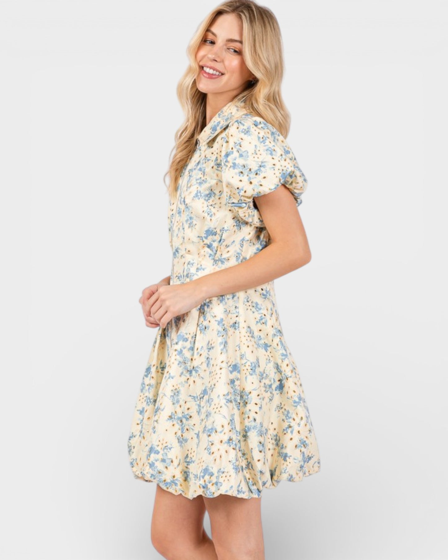 Woman wearing a floral dress on a plain background