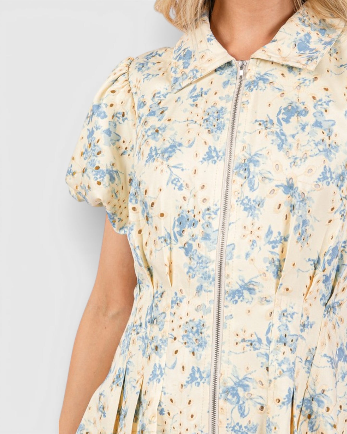 Woman wearing a floral dress with a white background