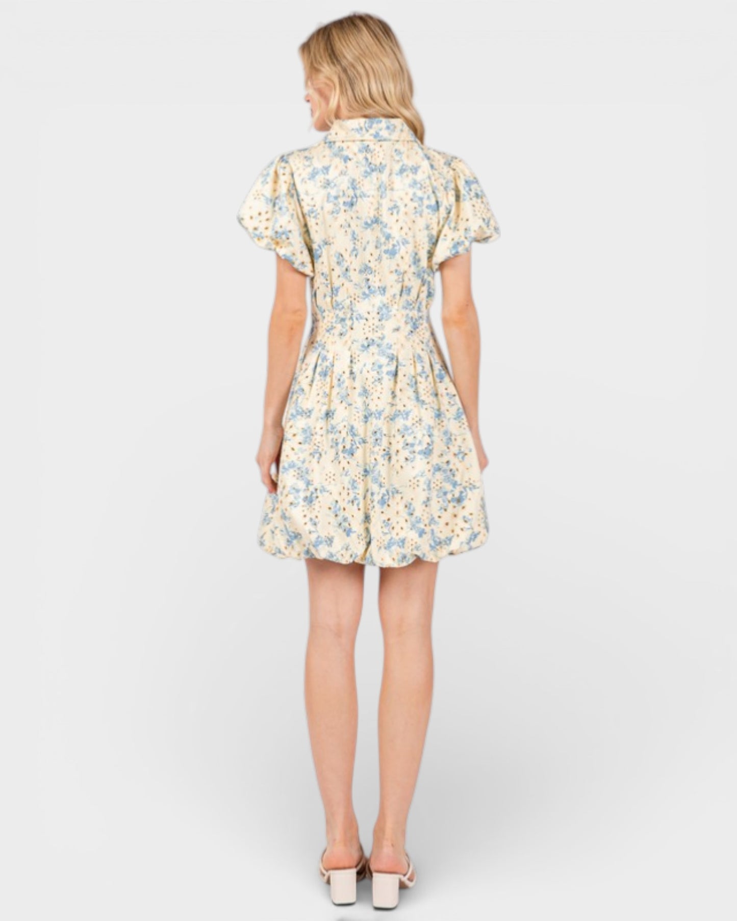 Woman wearing a floral dress on a white background