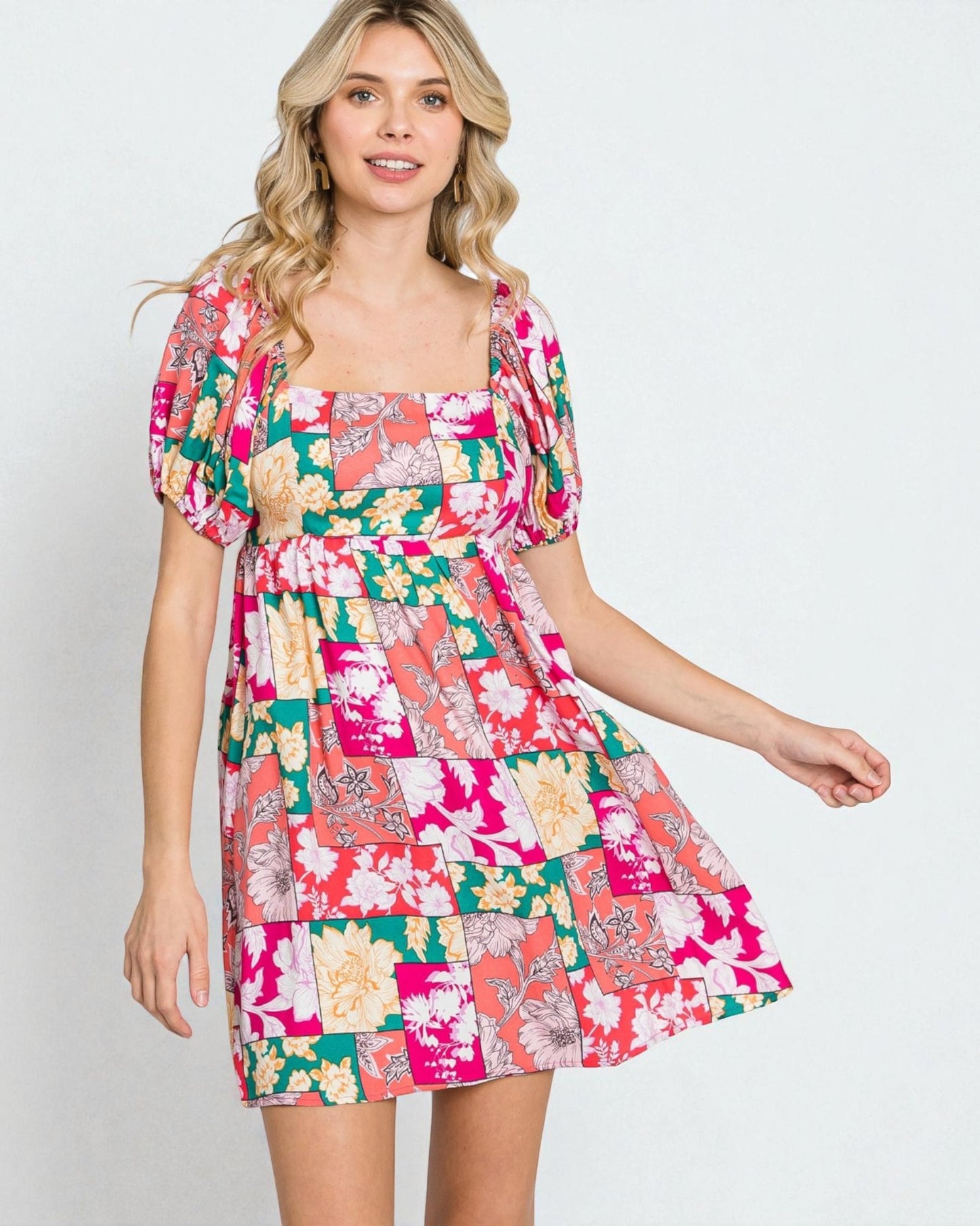 Woman wearing a colorful floral dress on a white background