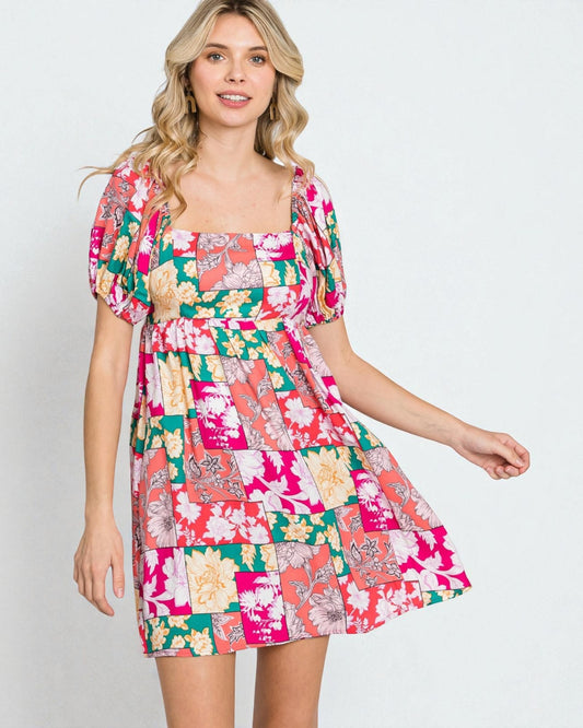 Woman wearing a colorful floral dress on a white background