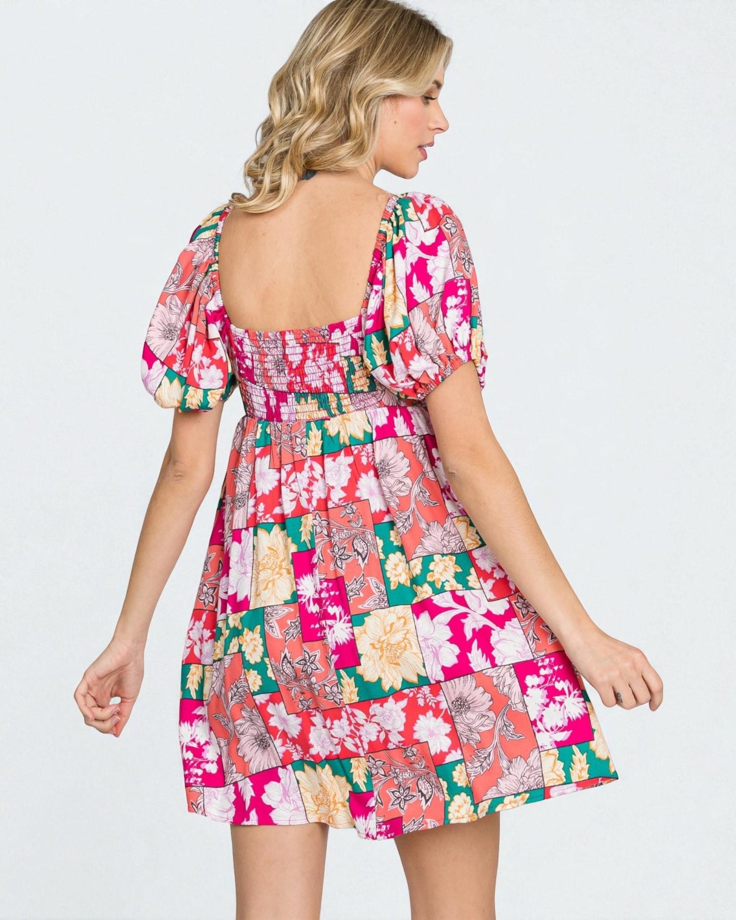 Woman wearing a colorful patchwork dress on a white background