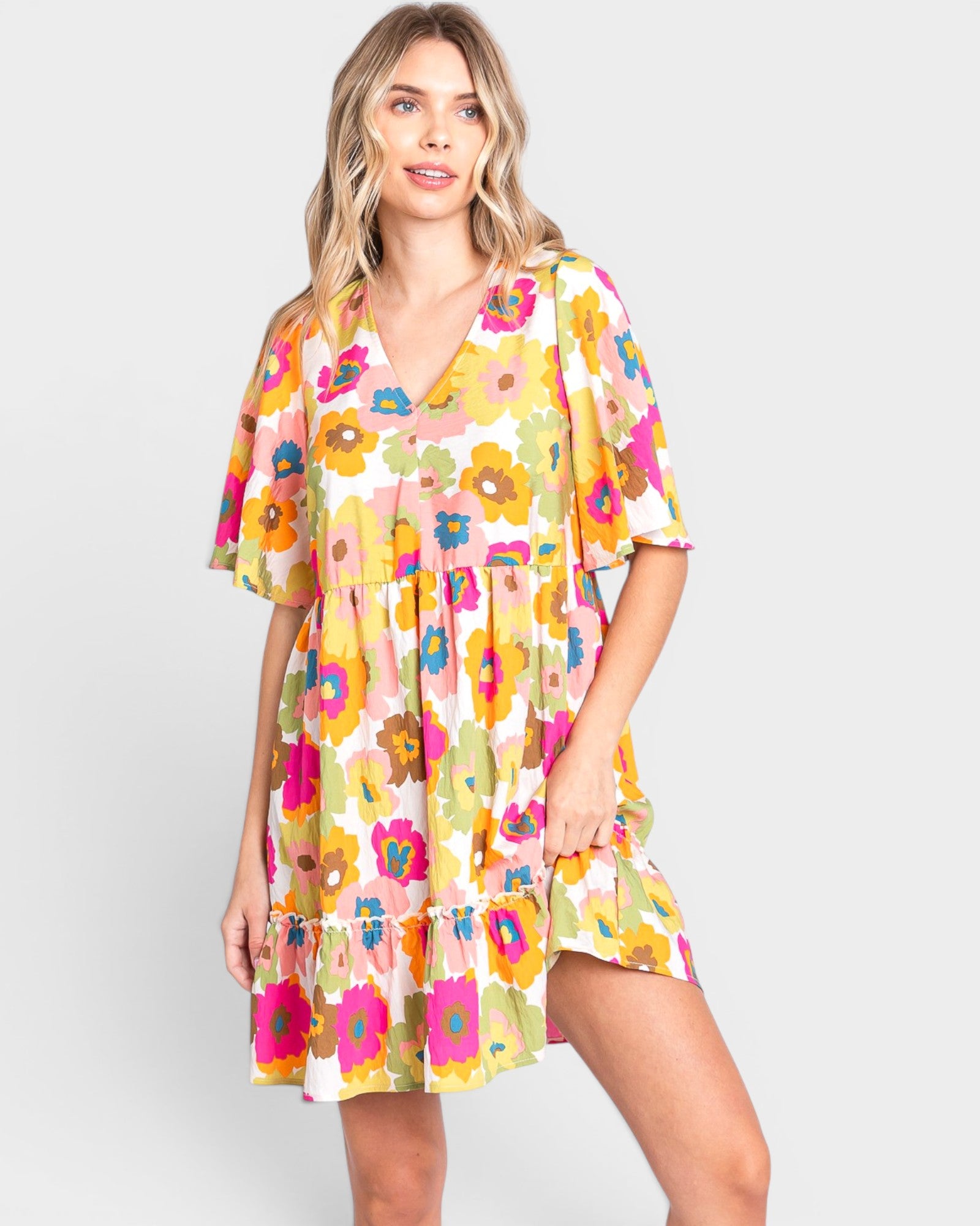 Woman wearing a colorful floral dress on a white background