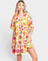 Woman wearing a colorful floral dress on a white background